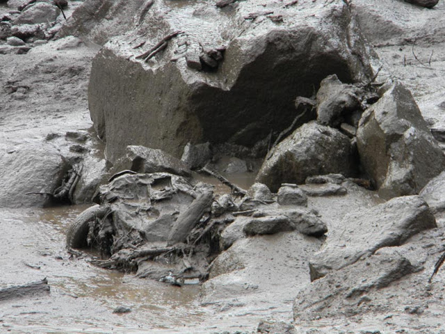 Vehicle buried in debris after flash flood hit the area