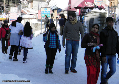 Tourists walk on Snow in Manali town