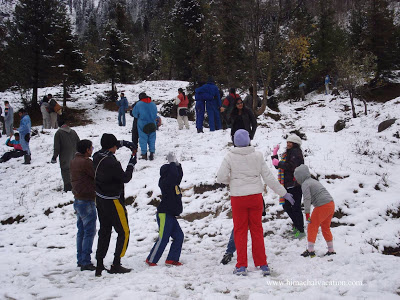 Tourists enjoy snowfall