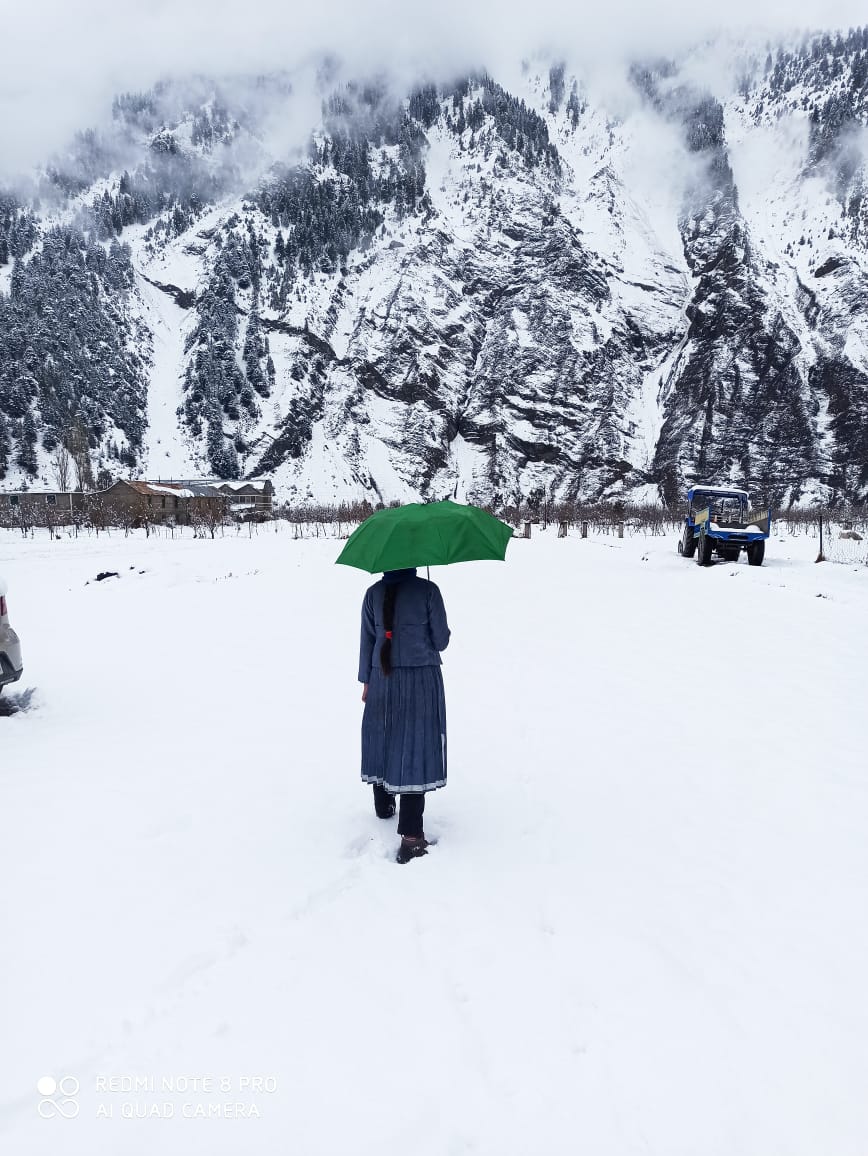 A girl in snowfall in Lahaul